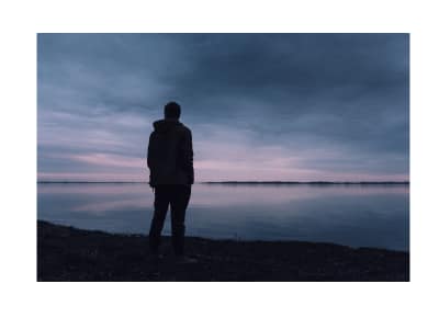 Person overlooking lake.
